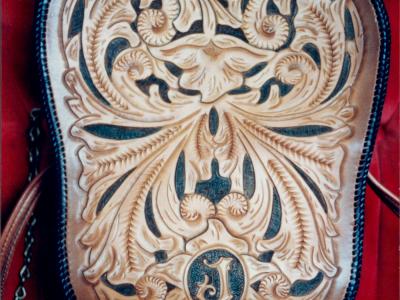 purse hand tooled with laced leather edges