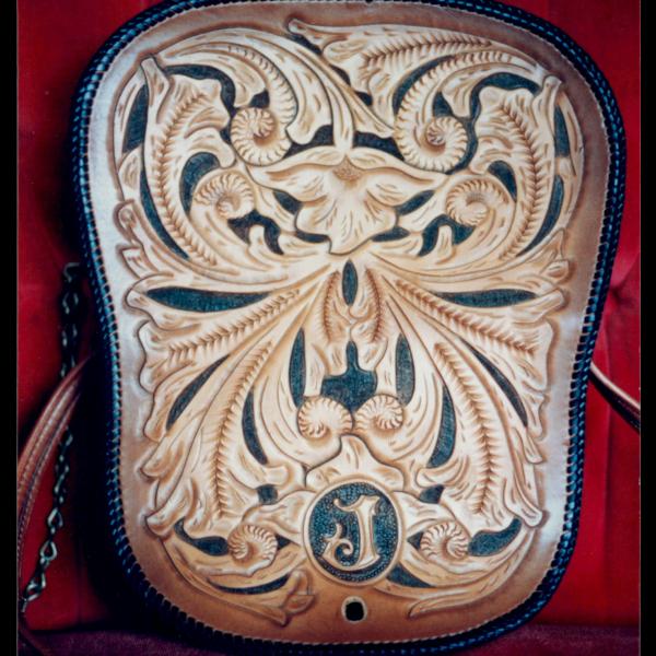 purse hand tooled with laced leather edges